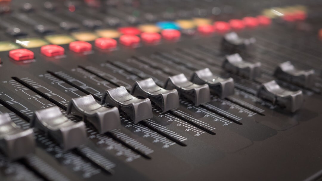 Close-up of professional broadcast camera and audio mixing console