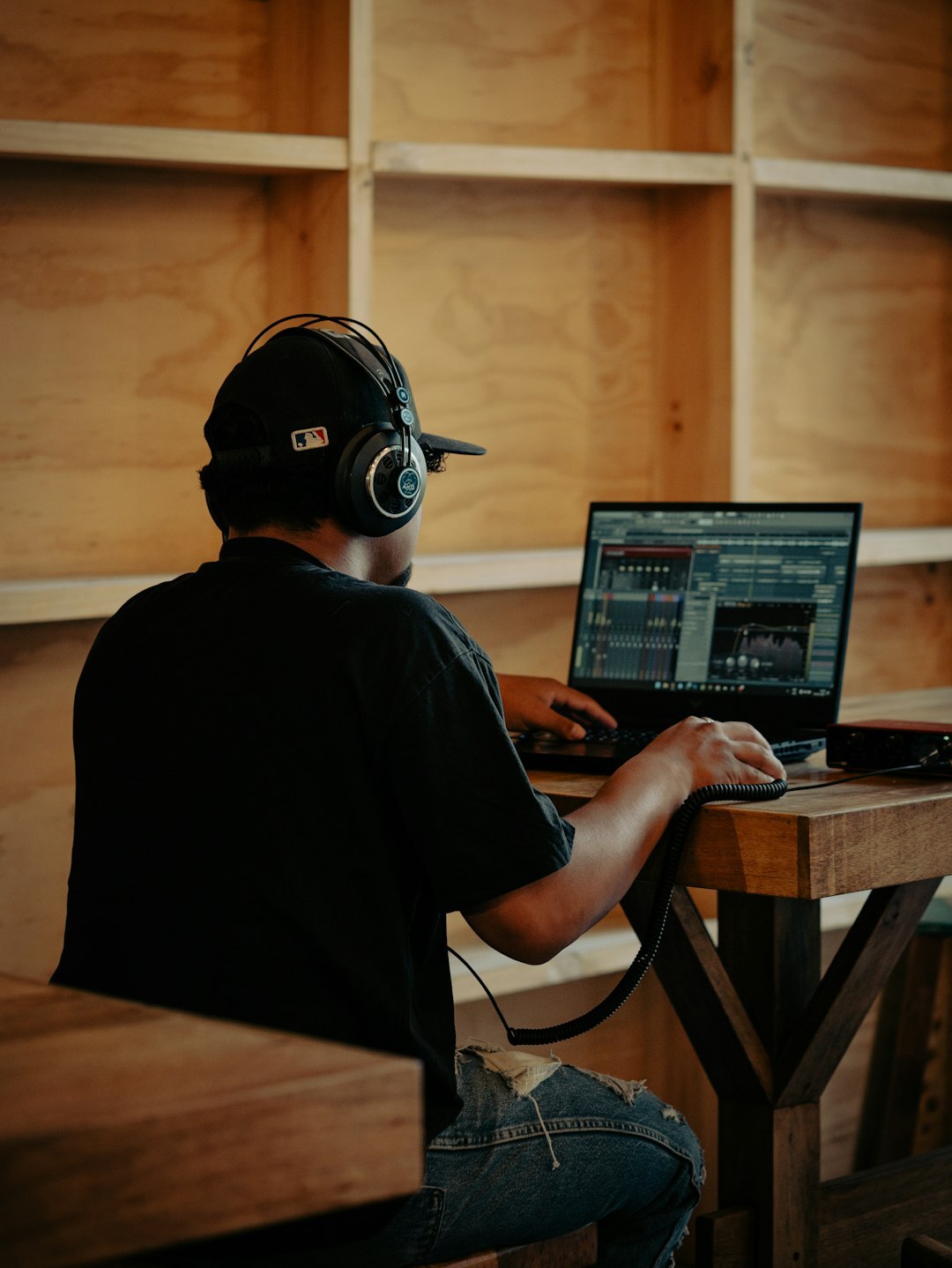 Sound engineer working at an audio mixing desk with headphones